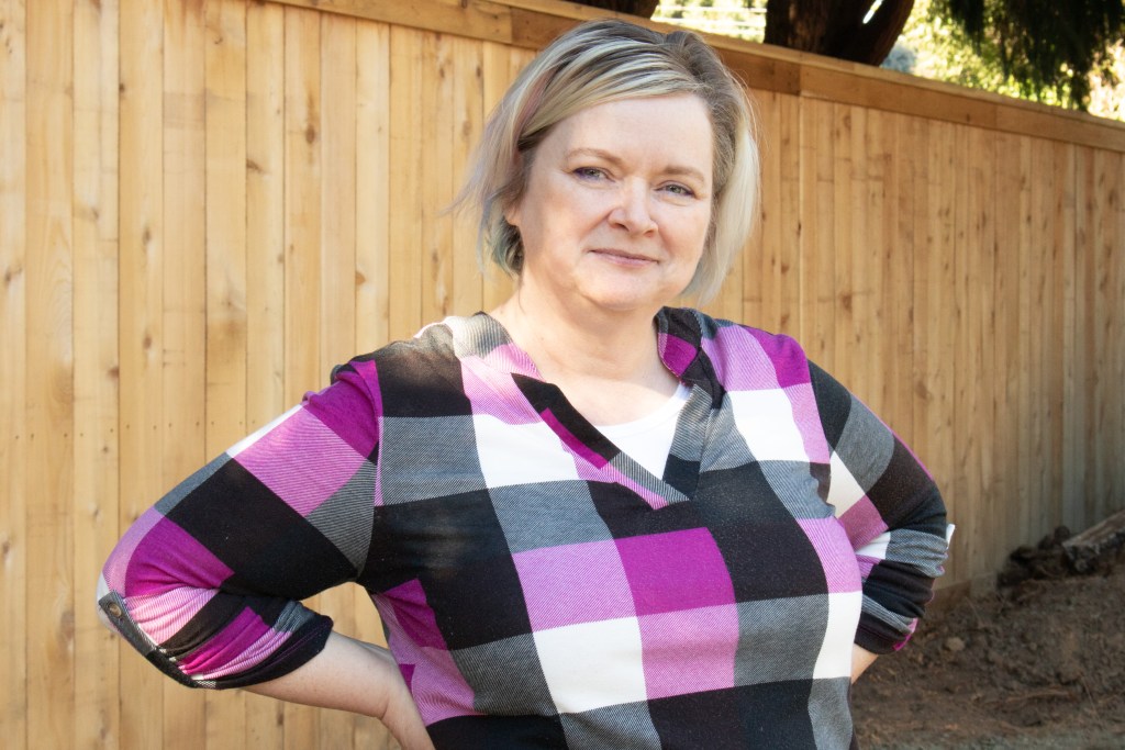 Kelley Mitchell (headshot) owner and curator of Frogging News a needlework blog.